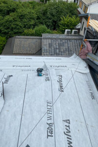 既存屋根の上から新たにルーフィングを敷いていきます